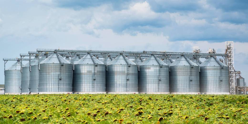 Distant view of sunflower oil refinery in a field View of sunflower oil plant . Factory for processing oil. Food industrial production.