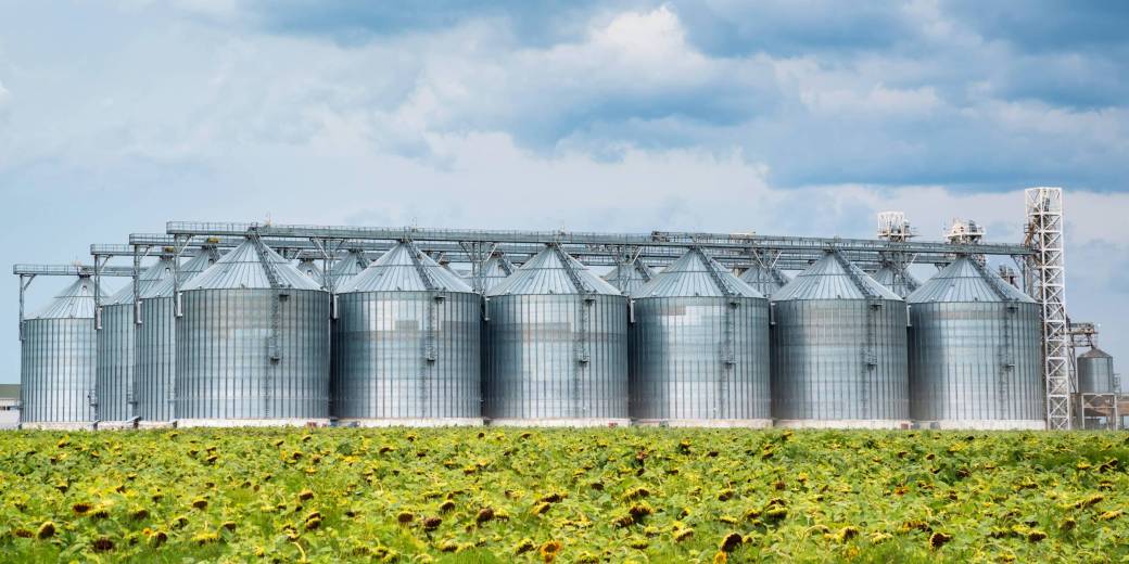 Distant view of sunflower oil refinery in a field View of sunflower oil plant . Factory for processing oil. Food industrial production.